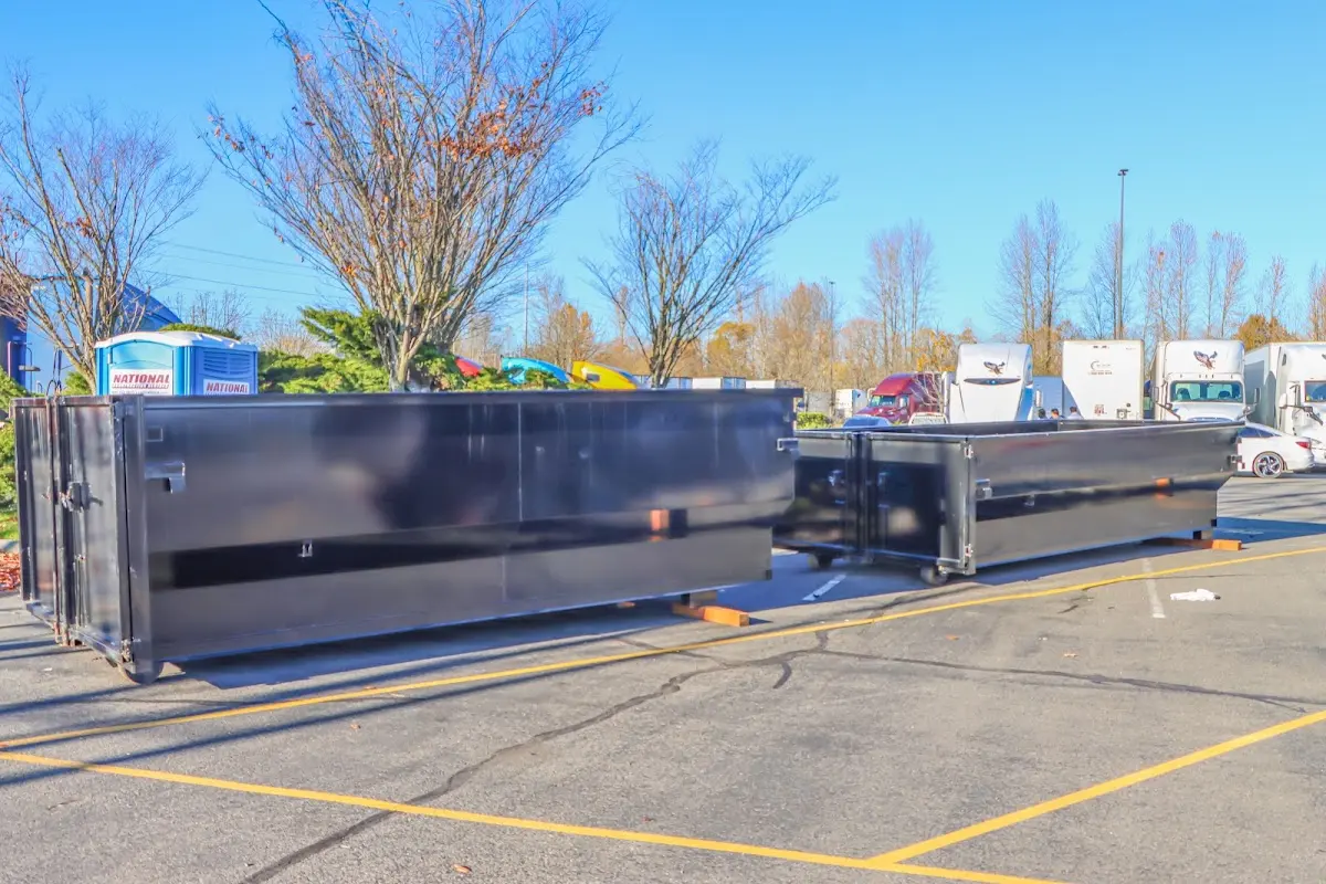 Professional dumpster rental service with roll-off container on residential driveway in Hamden